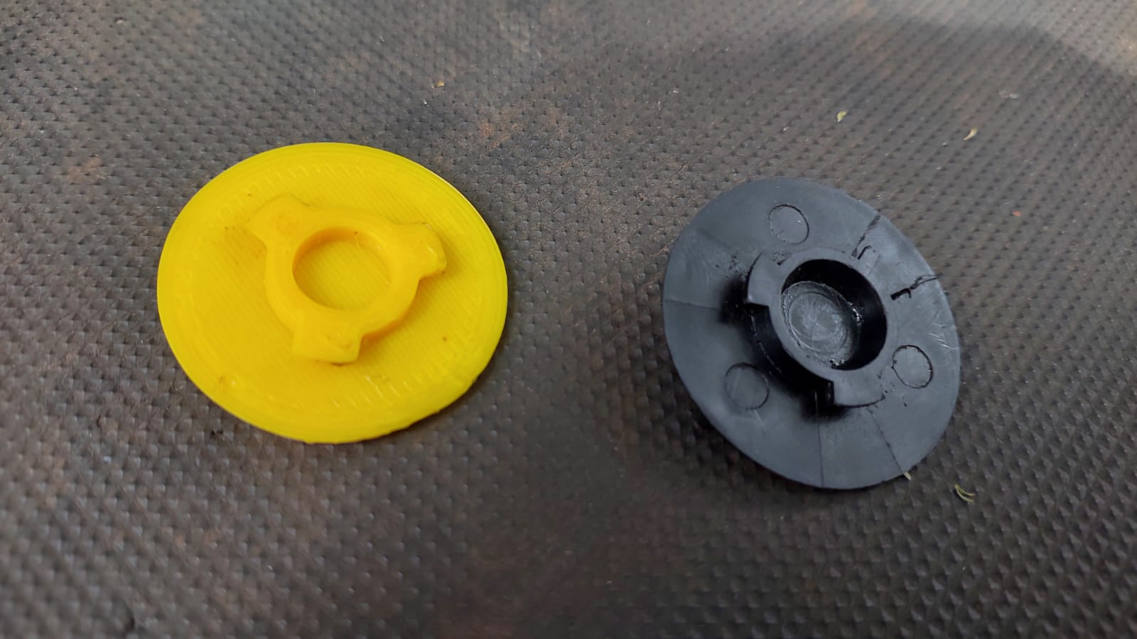 A yellow 3D-printed filter cap beside the original worn black part